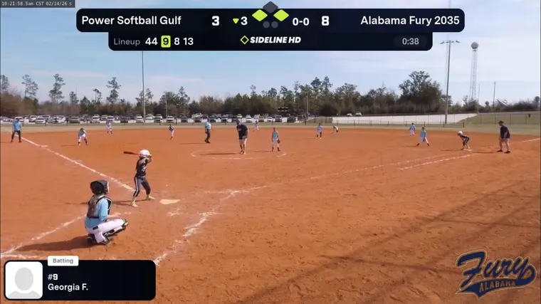 Live broadcast frame of a batter at the plate with the scoreboard and current lineup on screen